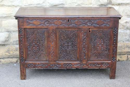 A Heavy Antique Oak Coffer, with decorative carving to the front panel, approx    cms