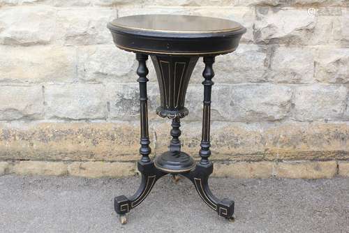 An Edwardian Circular Sewing Table; the  table having a hinged cover which opens to reveal a fitted interior, 50 d cms x 75 h cms