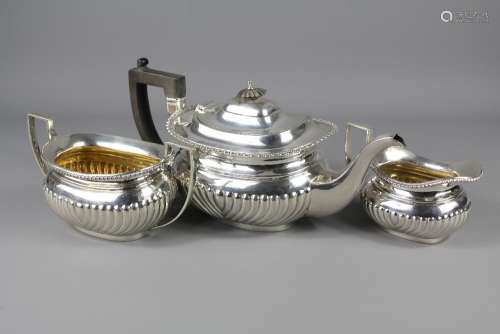 A Silver Tea Trio, comprising tea pot, sugar bowl and milk jug, London hallmark, dated 1919, mm B & P Ltd, approx 1026 gms
