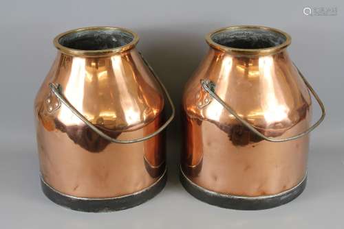 A Pair of Antique Copper Milk Churns, with a swing handle, heavy cast iron bases, approx 36 cms h, polished to a high finish