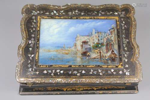 A French Black Lacquer Writing Slope, with decorative mother-of-pearl inlay, the slope painted with enamels depicting the Conciergerie on the Seine in Paris, approx 25 x 35 x 7 cms