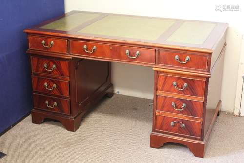 A Twin-Pedestal Office Desk, central drawer flanked by four drawers to either side, green tooled leather top, approx 145 w x 75 d cms