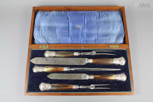 An Edwardian Silver and Horn Handled Carving Set, comprising two serving forks, two carving knives and a knife sharpener, Sheffield hallmark, dated 1907, mm Walker & Hall, in the original mahogany box