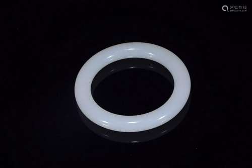 A WHITE JADE BANGLE.