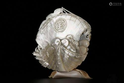 A CARVED PERAL SHELL BOAT.