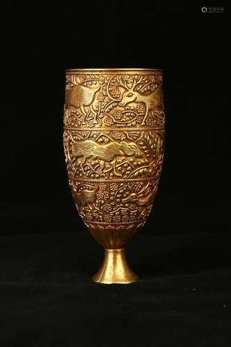 A CARVED GILT-SILVER CUP.ANTIQUE