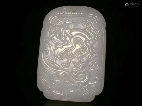 A CARVED WHITE JADE 'DRAGON' PENDANT.QING PERIOD