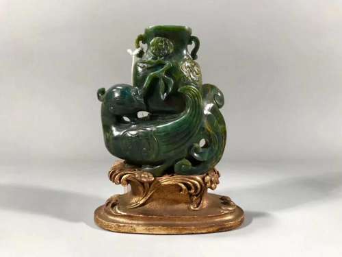 A CARVED SPINACH-GREEN JADE 'PHOENIX' CUP .QING PERIOD