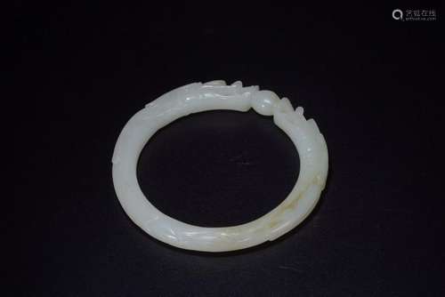 A CARVED JADE 'DRAGON' BANGLE.