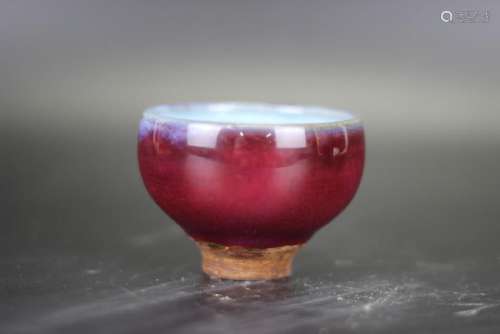 A RED GLAZED PORCELAIN CUP