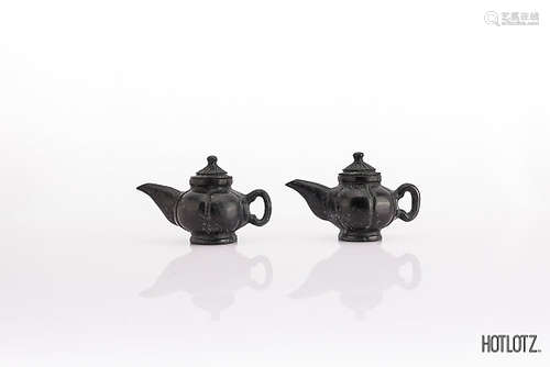 A PAIR OF CHINESE SMALL CARVED STONE TEAPOTS