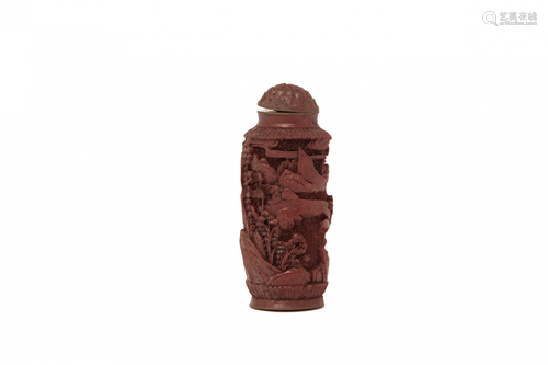 A CARVED CINNABAR SNUFF BOTTLE