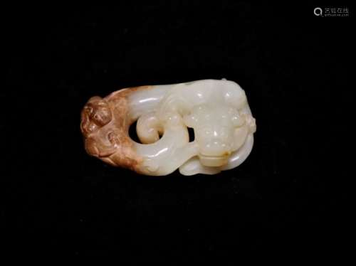 A white jade dragon-shaped pendant