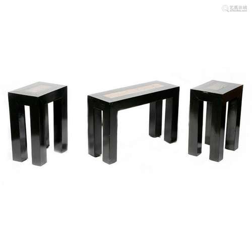 Three ebonized stone topped low tables.