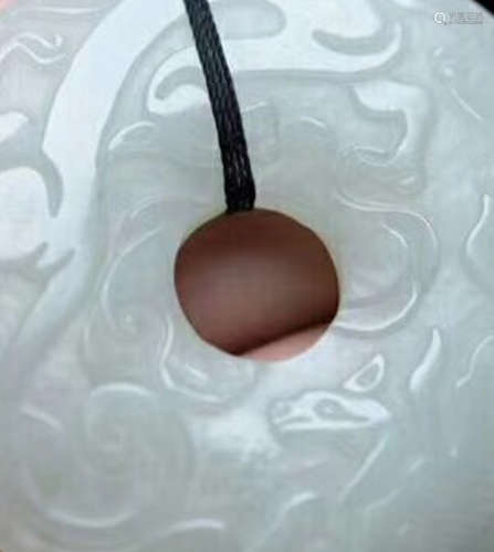 A HETIAN JADE CARVED CIRCLE PENDANT