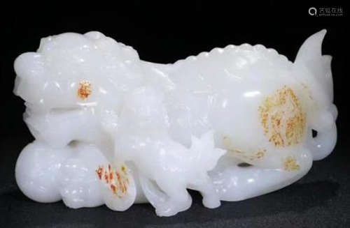 A HETIAN SUET JADE CARVED LION SHAPED PENDANT