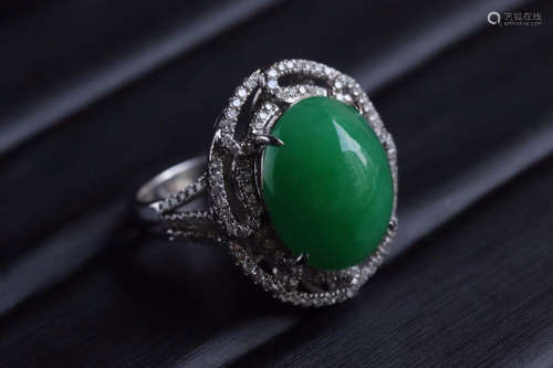 A JADEITE EGG SHAPED RING SURROUNDED WITH DIAMONDS
