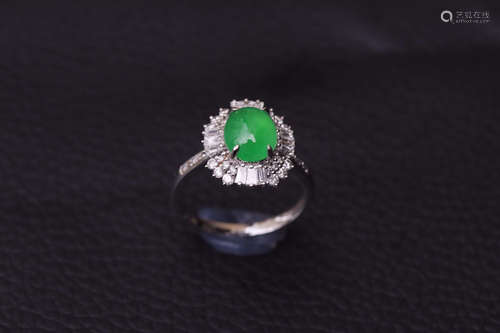 A ZHENGYANG GREEN EGG-SHAPED JADEITE RING SURROUNDED WITH DIAMONDS