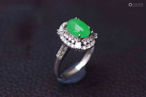 A ZHENGYANG GREEN EGG-SHAPED JADEITE RING SURROUNDED WITH DIAMONDS