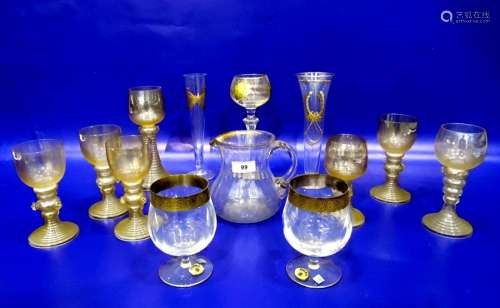 Eight various gilt tinted hock type wines with banded tapered stems and prunt decoration, a gilt