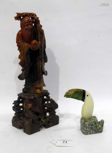 Carved soapstone figure of an elderly gentleman with staff carrying fruit on integral pierced base