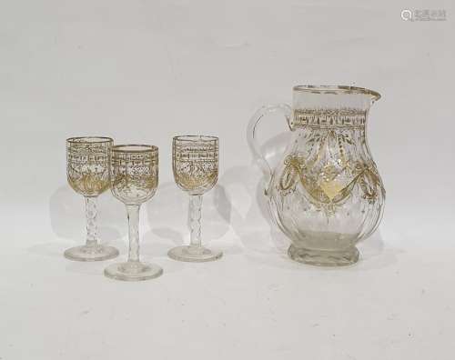 Late Victorian/Edwardian cut glass gilt jug faceted body floral and festoon decorated and three