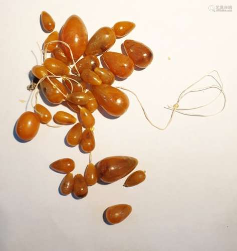 Quantity of amber graduated oval beads, unstrung,
