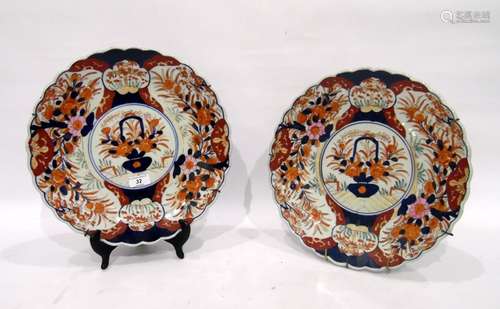 Pair of Imari chargers, late 19th/early 20th century, each painted with a central cartouche and