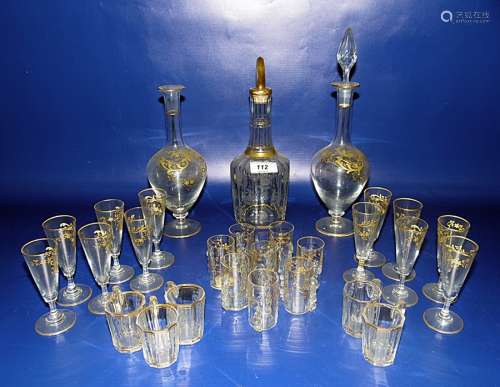 Gilt and clear glass liqueur decanter with floral etched decoration and five matching liqueur tots