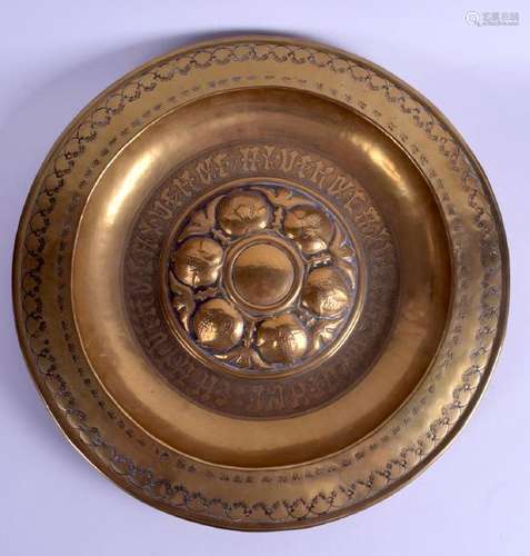 A LARGE ARTS AND CRAFTS BRASS ALMS DISH decorated with