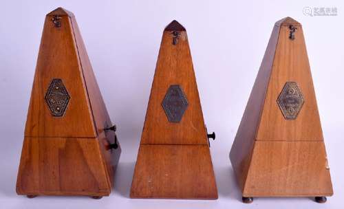 Three walnut cased Maelzel metronomes. (3)