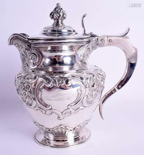 A LARGE SOLID SILVER CLARET JUG, decorated in relief