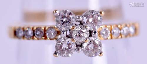 A GOLD AND DIAMOND DAISY CLUSTER RING. 3.6 grams. Size