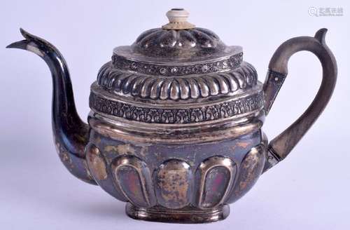 AN EARLY SOLID SILVER TEA POT, decorated with floral