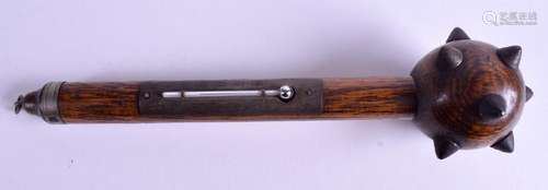 An oak novelty thermometer in the form of a studded