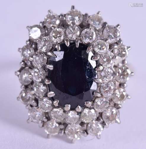 AN 18CT GOLD DIAMOND AND SAPPHIRE CLUSTER RING. 8.1