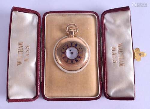 AN ANTIQUE CASED YELLOW METAL WALTHAM HALF HUNTER