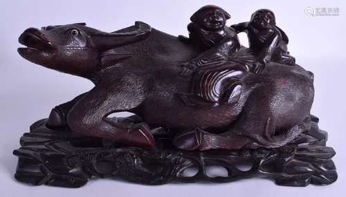 A LARGE 19TH CENTURY CHINESE CARVED HARDWOOD BUFFALO.