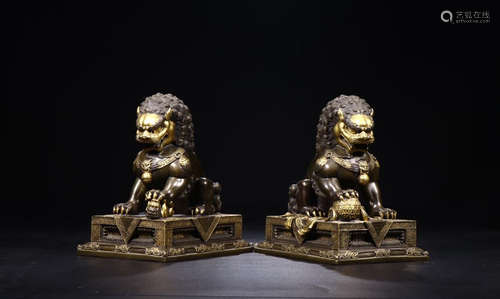 PAIR OF QIANLONG GILT BRONZE LION ORNAMENTS