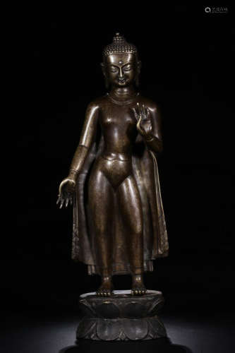 A COPPER STANDING BUDDHA