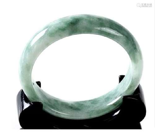 A NATURAL JADEITE JADE BANGLE.