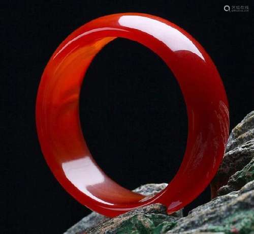 A NATURAL RED AGATE JADE BANGLE.