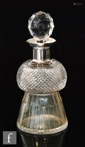 A late 19th Century small decanter modelled as a thistle, the clear glass cut body below silver