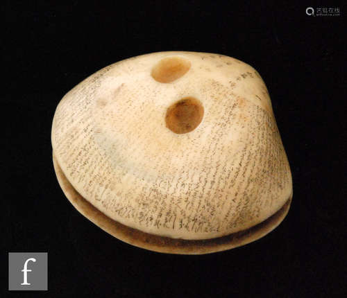 A late 19th/early 20th Century anabori clam shell ivory netsuke, the carved ivory shell with small