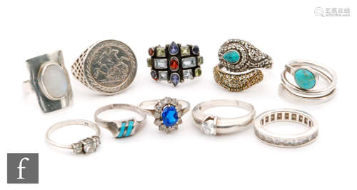 Ten assorted silver and white metal rings to include stone set and enamelled examples. (10)