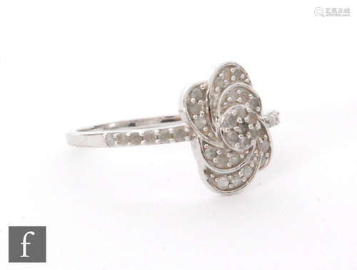 A modern 9ct hallmarked diamond cluster ring, the pave set flat head with scroll borders to