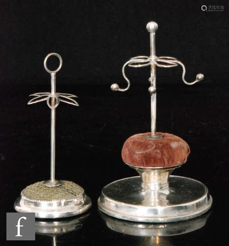 An Edwardian hallmarked silver hat pin holder/ring tree, circular base below central brown cushion