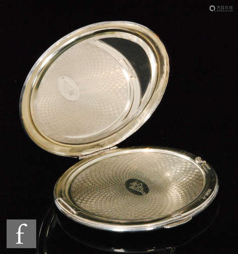 A hallmarked silver circular compact with engine turned decoration to whole with original internal