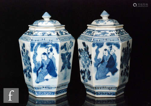 A pair of Chinese blue and white Kangxi style faceted jars, each of hexagonal form, surmounted by