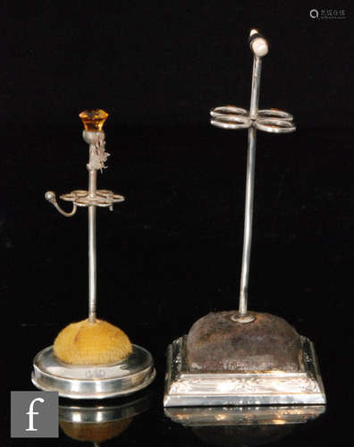 A hallmarked silver hat pin stand, square base with blue cushion, with a similar smaller example,